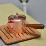 Koperen theepot met houten handvat en hamerslag — Schenkkan met wijde tuit