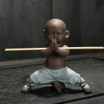 Kungfu-monnik tea pet van paarse klei — 1 beeldje, gehurkt met de handen tegen elkaar, heel lichtblauw