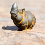 Neushoorn beeldje van hars met roestkleurige afwerking