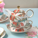 Porseleinen theepot met kopje en bloemendecor
